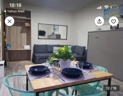 a table with plates and bowls on it in a living room at Estudio playa la muralla in El Puerto de Santa María