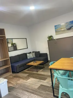 a living room with a couch and a table at Estudio playa la muralla in El Puerto de Santa María