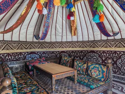 a room with a table and two chairs in a yurt at La via de la Yurta in Cádiz