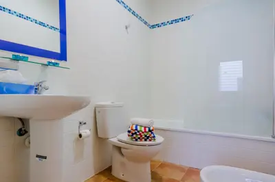 a bathroom with a toilet and a sink at Apartamentos Ribera del Puerto in El Puerto de Santa María