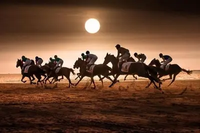 a group of people riding horses on the beach at Apartamentos Sanlúcar & Doñana in Sanlúcar de Barrameda