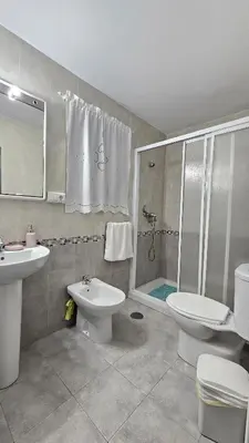 a bathroom with a toilet and a sink and a shower at Casa de la Abuela Rosario in Sanlúcar de Barrameda