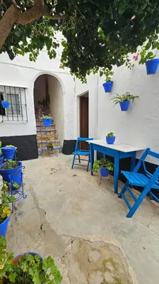 a blue table and chairs in front of a building at Casa de la Abuela Rosario in Sanlúcar de Barrameda