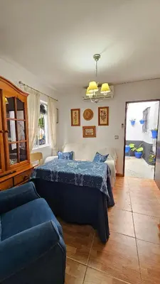 a bedroom with two beds and a couch at Casa de la Abuela Rosario in Sanlúcar de Barrameda