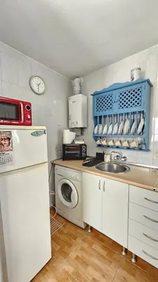 a kitchen with a sink and a washing machine at Casa de la Abuela Rosario in Sanlúcar de Barrameda