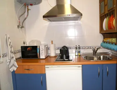 a kitchen with a sink and a microwave at Rincón Centro exclusive in Jerez de la Frontera
