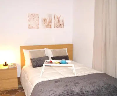 a bedroom with a bed with a tray on it at Rincón Centro exclusive in Jerez de la Frontera