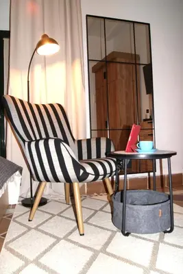 a living room with a chair and a table at Rincón Centro exclusive in Jerez de la Frontera