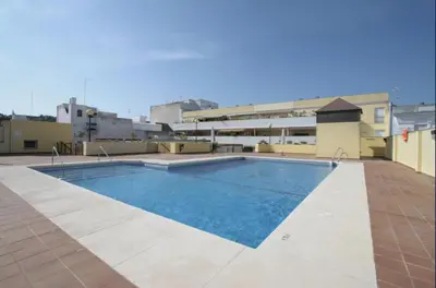 a swimming pool on top of a building at Apartamento en el centro con garaje, terraza, wifi, climatización y piscina in Sanlúcar de Barrameda