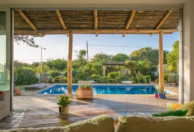 an open living room with a pool in a house at Exotic Beachfront Retreat Handcrafted Bohemian Luxury in Cádiz