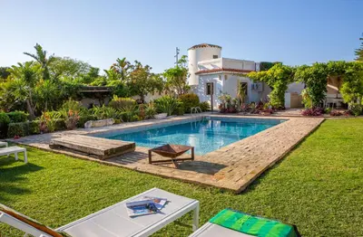 a swimming pool in the backyard of a house at Exotic Beachfront Retreat Handcrafted Bohemian Luxury in Cádiz