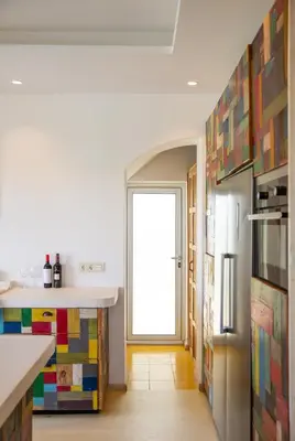 a kitchen with colorful tiles on the wall at Exotic Beachfront Retreat Handcrafted Bohemian Luxury in Cádiz