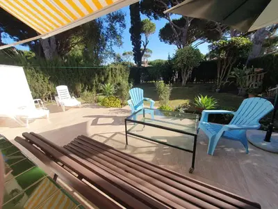 two blue chairs and a bench on a patio at La casa bianca in Novo Sancti Petri
