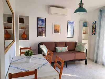 a living room with a couch and a table at La casa bianca in Novo Sancti Petri