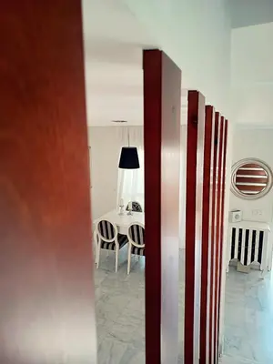 a room with a table and a table and chairs at Vive Sanlúcar con aparcamiento en la puerta in Sanlúcar de Barrameda