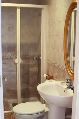 a bathroom with a toilet and a sink and a shower at Vive Sanlúcar con aparcamiento en la puerta in Sanlúcar de Barrameda