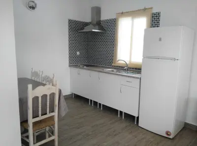 a kitchen with a white refrigerator and a sink at ALOJAMIENTo RURAL IZAN in Conil de la Frontera