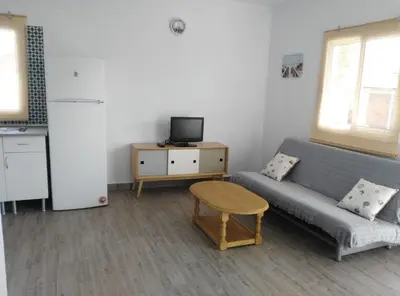 a living room with a couch and a tv at ALOJAMIENTo RURAL IZAN in Conil de la Frontera