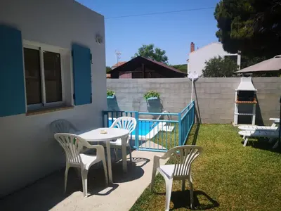 a patio with a table and chairs and a fence at ALOJAMIENTo RURAL IZAN in Conil de la Frontera