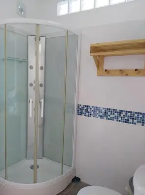 a glass shower in a bathroom with a toilet at ALOJAMIENTo RURAL IZAN in Conil de la Frontera