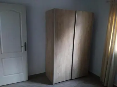 a wooden cabinet in a room next to a door at Casa MARINERA in Cádiz