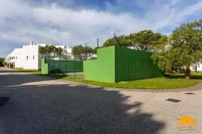 a green building on the side of a street at Retama Golf by Cadiz Time in Novo Sancti Petri
