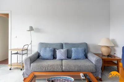 a living room with a couch with blue pillows at Retama Golf by Cadiz Time in Novo Sancti Petri