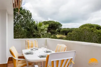 a white table and chairs on a balcony at Retama Golf by Cadiz Time in Novo Sancti Petri