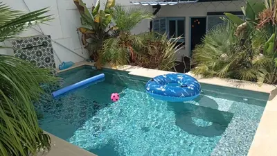 a swimming pool with a pool noodle in a backyard at Oasis de Bornos Maison Entière in Bornos