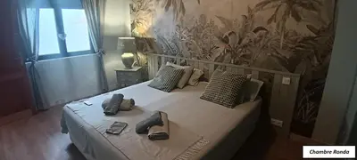 a bedroom with a bed with shoes on it at Oasis de Bornos Maison Entière in Bornos