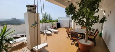 a patio with a table and chairs on a balcony at Atico Arcos Terraza Relax in Arcos de la Frontera