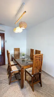 a dining room table with four chairs and two lights at Atico Arcos Terraza Relax in Arcos de la Frontera