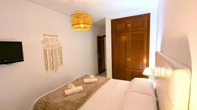 a bedroom with a bed with two towels on it at Atico Arcos Terraza Relax in Arcos de la Frontera