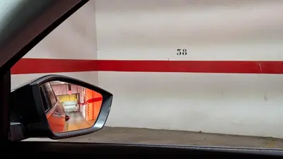 a side view mirror of a car with a red and white wall at Atico Arcos Terraza Relax in Arcos de la Frontera