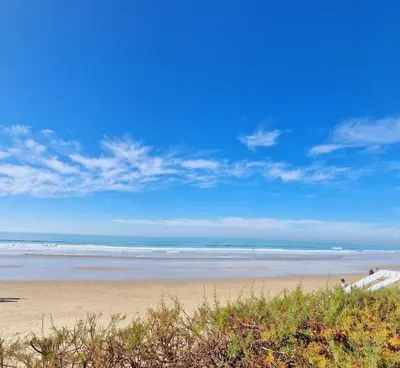 a sandy beach with a view of the ocean at Librada de las olas in Cádiz