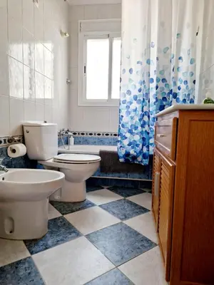 a bathroom with a toilet and a sink at Librada de las olas in Cádiz