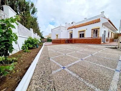 a house with a tiled courtyard in front of it at Librada de las olas in Cádiz