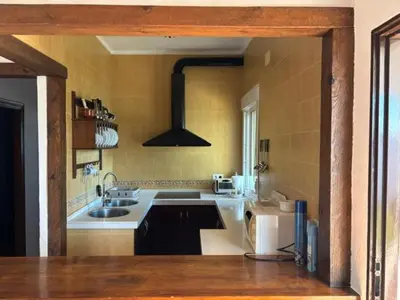 a kitchen with a sink and a stove at Chalet Rancapinos en Rocheviejo CONIL in Cádiz