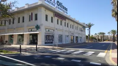 a large white building on the corner of a street at EXCLUSIVE APARTMENT 3 HAB Wifi in Rota