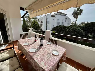 a table with two bottles of wine on a balcony at EXCLUSIVE APARTMENT 3 HAB Wifi in Rota