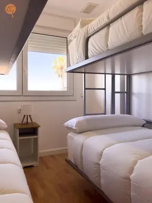 a bedroom with two bunk beds and a window at Miramar Grupo AC Gestion in Cádiz