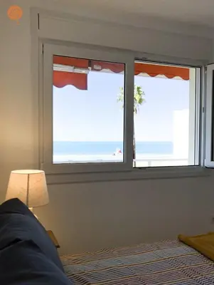 two windows in a bedroom with a view of the ocean at Miramar Grupo AC Gestion in Cádiz