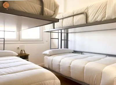 a room with two bunk beds and a window at Miramar Grupo AC Gestion in Cádiz