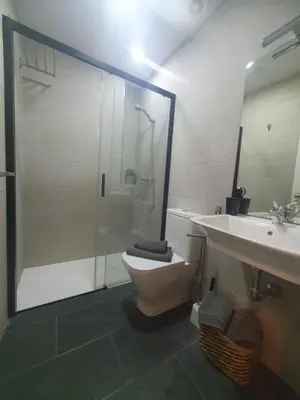 a bathroom with a shower and a toilet and a sink at Casa Parque Genovés junto a la playa in Cádiz