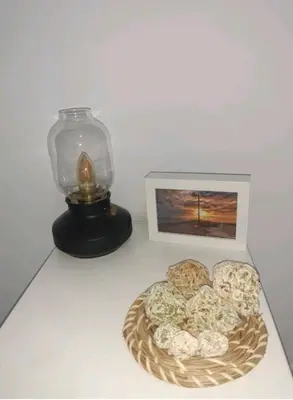 a plate of cookies next to a picture and a lamp at Casa Parque Genovés junto a la playa in Cádiz
