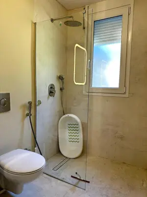 a bathroom with a shower and a toilet and a window at Casa singular completamente reformada in El Puerto de Santa María