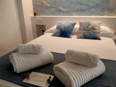 a bedroom with a bed with two pillows on it at La Cueva del Corregidor in Arcos de la Frontera