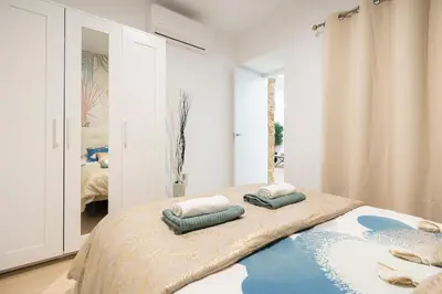 a bedroom with a bed with two pillows on it at Falla Loft & Beach in Cádiz