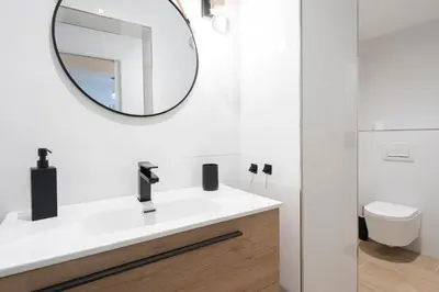 a bathroom with a white sink and a mirror at Falla Loft & Beach in Cádiz