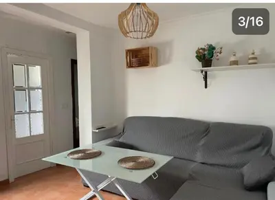 a living room with a couch and a table at Apartamento Reina Mercedes in Chipiona